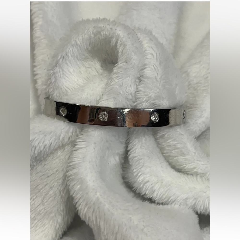 Silver toned stainless steel bangle bracelets with clear sparkling gemstones